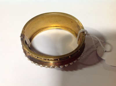 Lot 212 - A Victorian yellow metal half hinged bangle set with pearls.