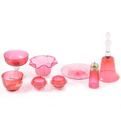 Lot 31 - Eight pieces of cranberry glass, a 26cm bell, an 18cm shallow dish with gold flecks, dishes, sugar caster, fluted dish, pair of dishes.