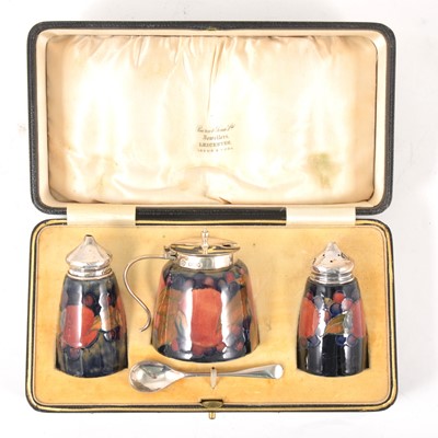 Lot 15 - A three-piece silver-mounted William Moorcroft 'Pomegranate' pattern cruet