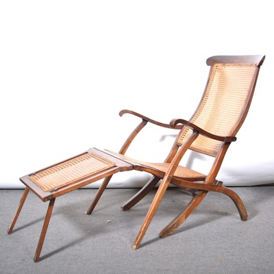 Lot 100 - A stained beech and cane bergere panelled steamer chair.