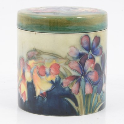 Lot 153 - William Moorcroft, a 'Spring Flowers' pattern cylindrical jar and cover.
