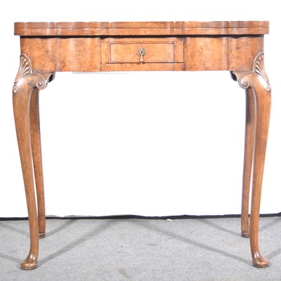 Lot 501 - A Queen Anne style burr walnut fold-over card table.