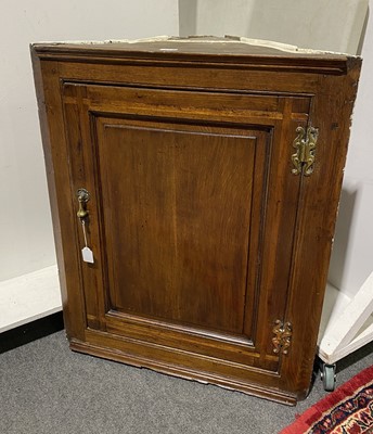 Lot 686 - George II oak and fruitwood banded hanging corner cupboard