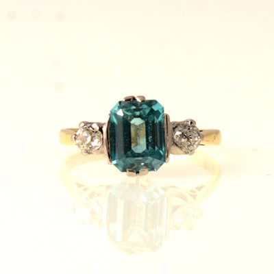 Lot 75 - A three stone ring with diamonds and aqua coloured stone.
