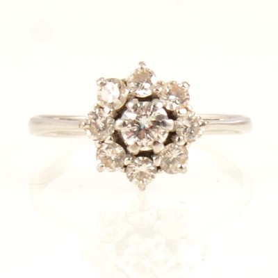 Lot 64 - A circular diamond cluster ring.