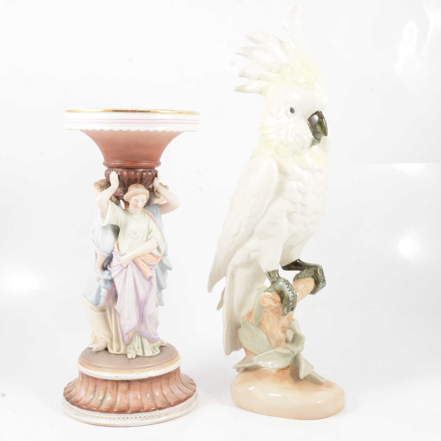 Lot 11 - A Royal Dux cockatoo with yellow plumage and a continental coloured bisque figure group.