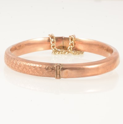 Lot 350 - A 9 carat rose gold half hinged bangle.