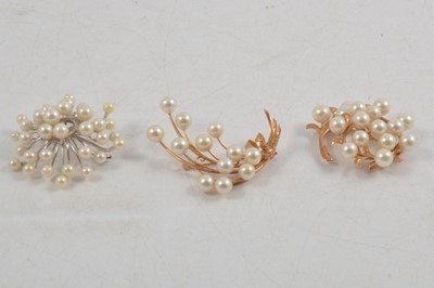 Lot 285 - Three cultured pearl brooches, two with 14K settings.