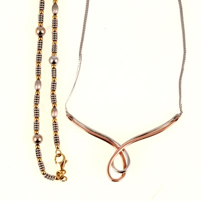 Lot 256 - A 9 carat yellow and white gold bead necklace and diamond set necklace.