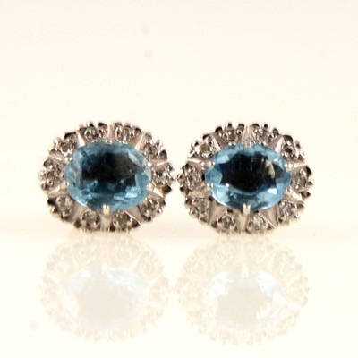 Lot 237 - A pair of aquamarine and diamond oval cluster earrings.