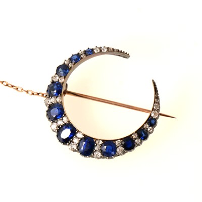 Lot 88 - A sapphire and diamond closed crescent brooch.