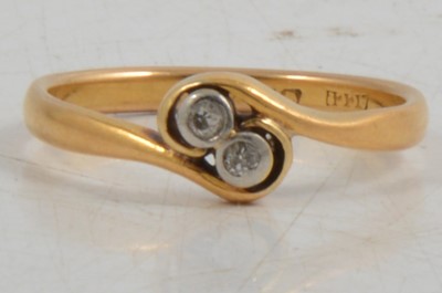 Lot 254 - A diamond two stone crossover ring in 22 carat gold.