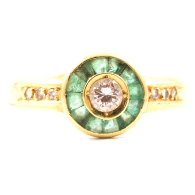Lot 38 - An emerald and diamond cluster ring.