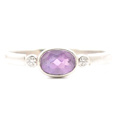 Lot 46 - An amethyst and diamond three stone ring.