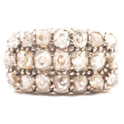 Lot 18 - A diamond three row half hoop ring.