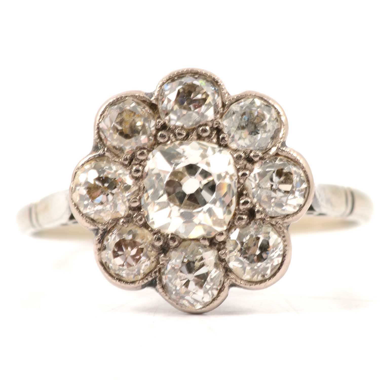 Lot 18 - A nine stone diamond cluster ring.