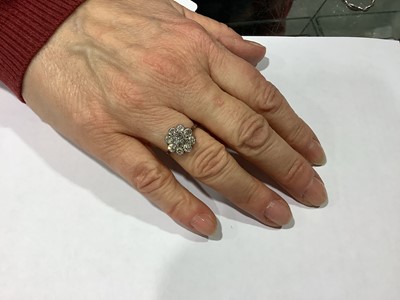 Lot 18 - A nine stone diamond cluster ring.