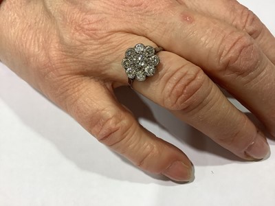 Lot 18 - A nine stone diamond cluster ring.