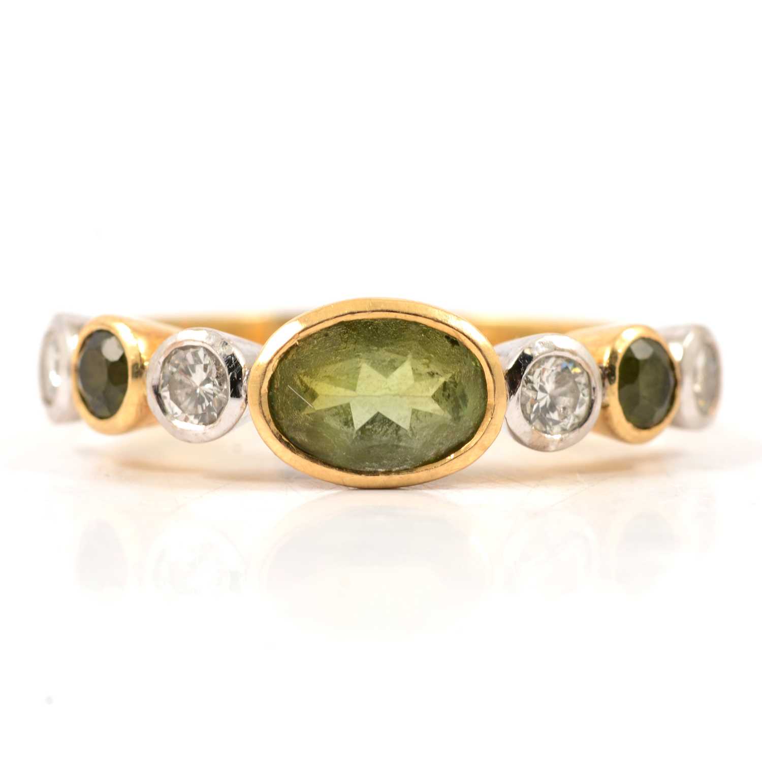 Lot 27 - A peridot and diamond half hoop ring.