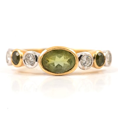 Lot 27 - A peridot and diamond half hoop ring.