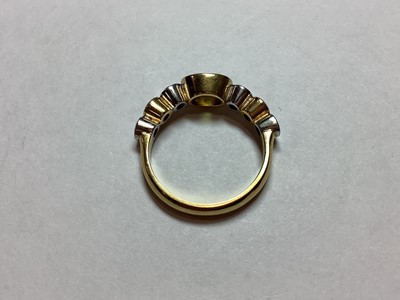 Lot 27 - A peridot and diamond half hoop ring.