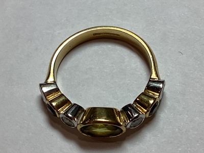 Lot 27 - A peridot and diamond half hoop ring.