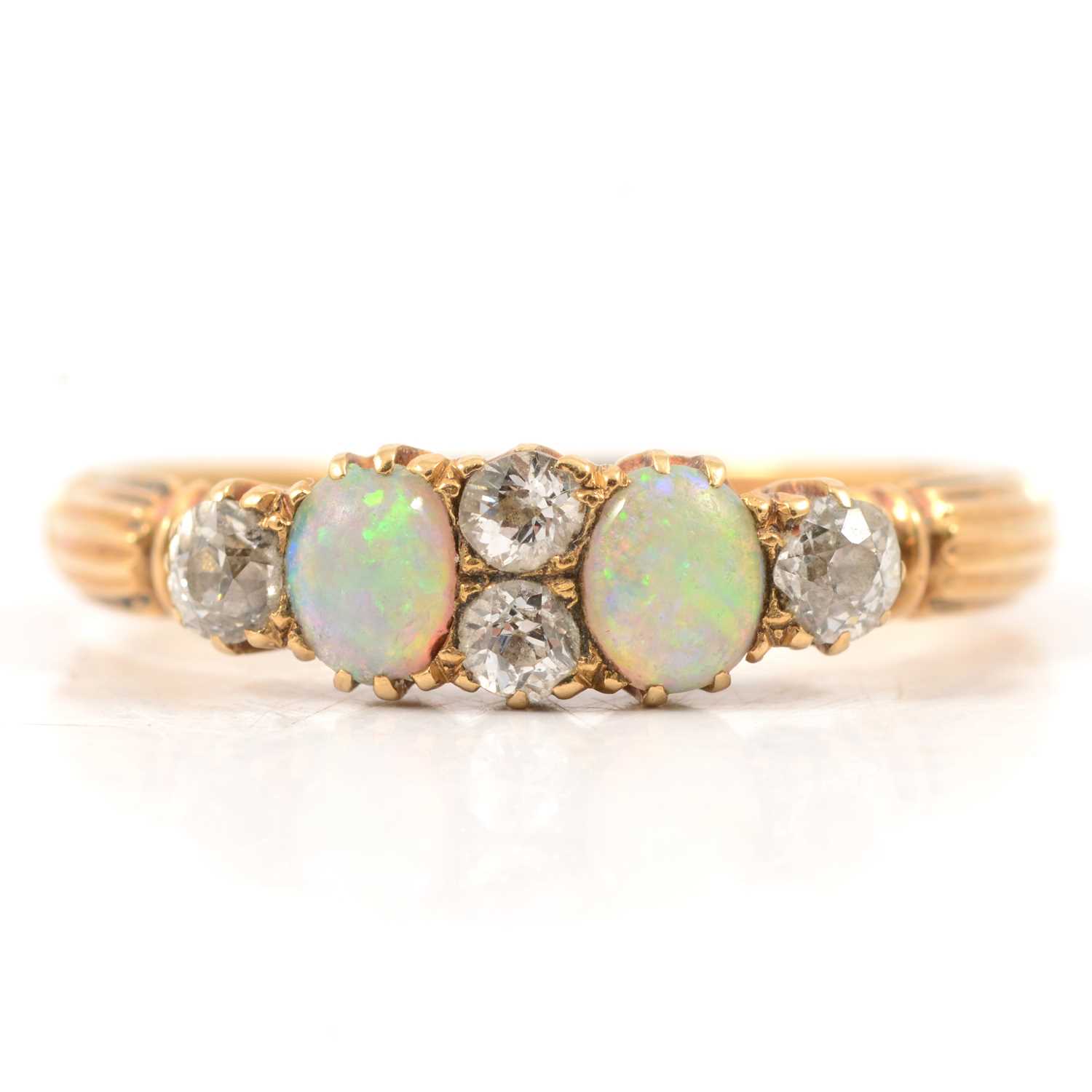 Lot 51 - An opal and diamond half hoop ring.