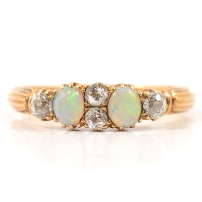 Lot 51 - An opal and diamond half hoop ring.