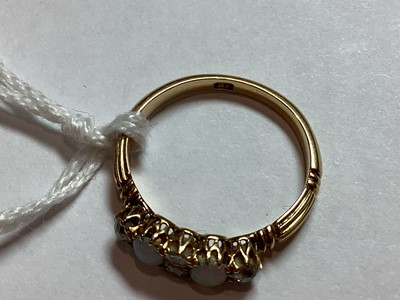Lot 51 - An opal and diamond half hoop ring.