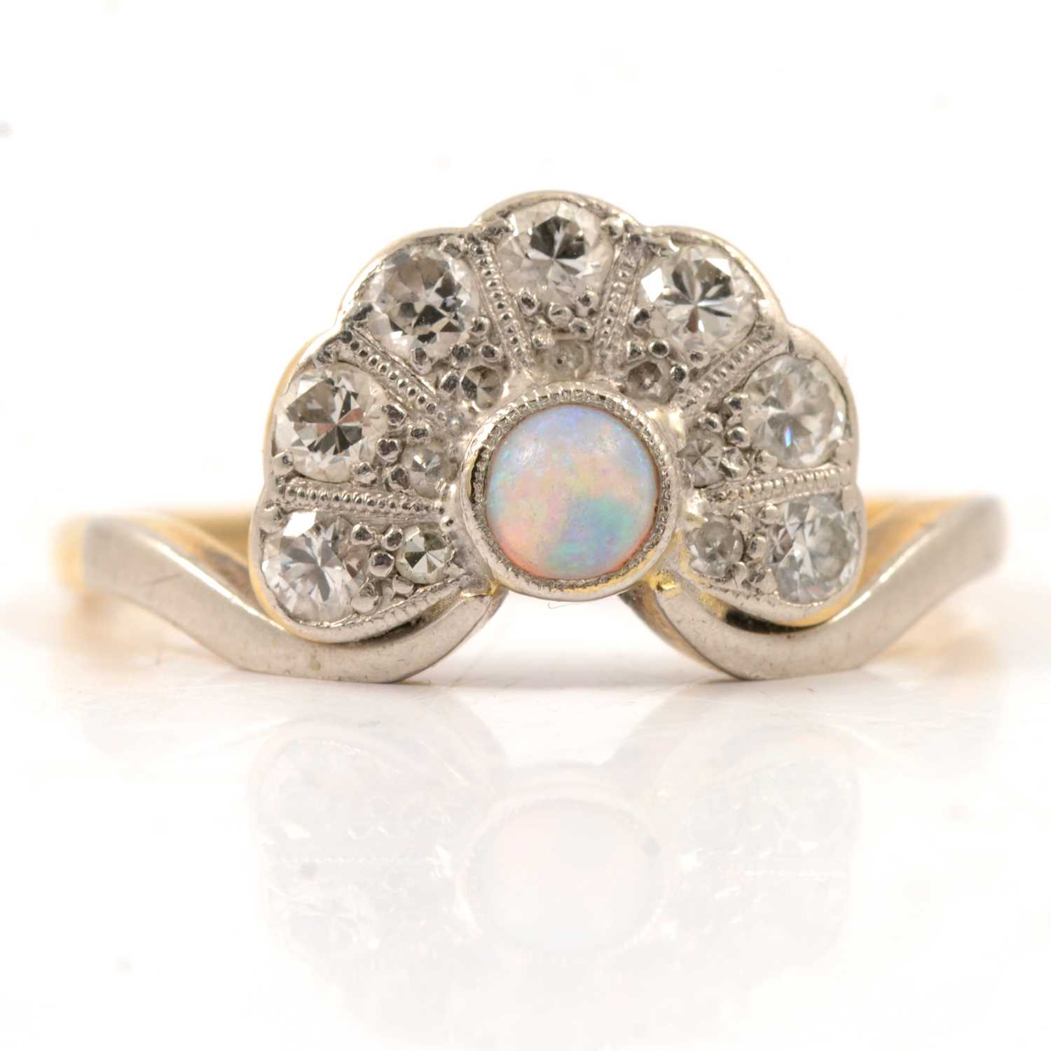 Lot 48 - An opal and diamond fan shaped ring.