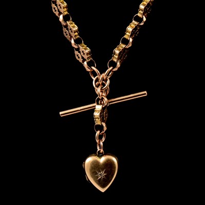 Lot 258 - A yellow metal double Albert watch chain with locket attached.