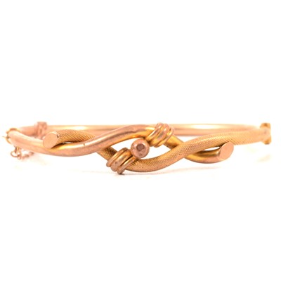 Lot 160 - A knot design hollow half hinged bangle.