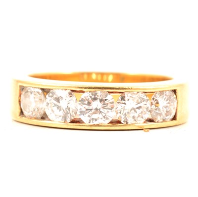 Lot 28 - A diamond five stone eternity ring.