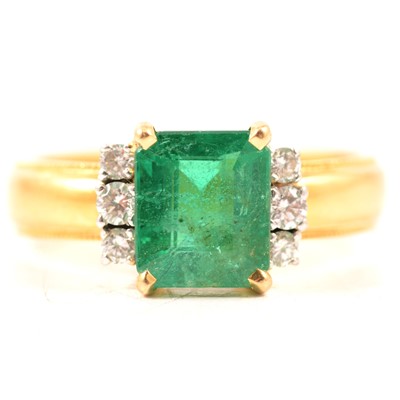 Lot 62 - An emerald and diamond ring.