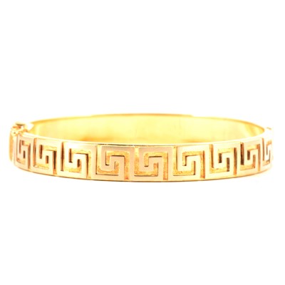 Lot 159 - A yellow metal half hined  bangle, Greek key design.