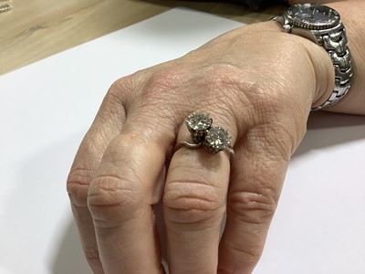 Lot 11 - A diamond two stone crossover ring.