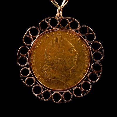 Lot 114 - A Gold Spade Guinea pendant and chain.