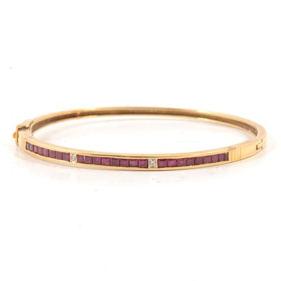 Lot 156 - A ruby and diamond half hinged bangle.