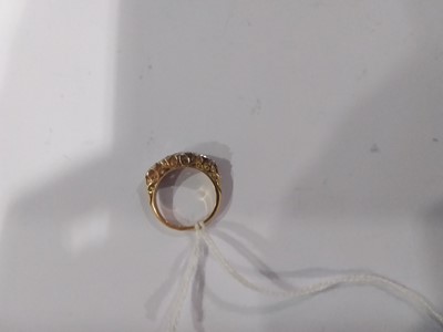 Lot 18 - A diamond five stone reproduction Victorian clarved claw ring.