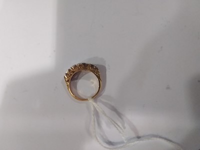Lot 18 - A diamond five stone reproduction Victorian clarved claw ring.