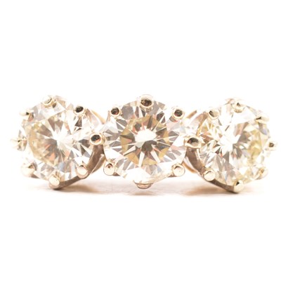 Lot 12 - A diamond three stone ring.