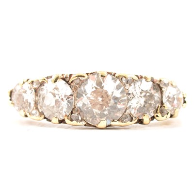 Lot 17 - A diamond five stone half hoop ring.