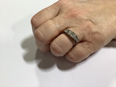 Lot 17 - A diamond five stone half hoop ring.