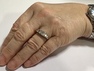 Lot 17 - A diamond five stone half hoop ring.