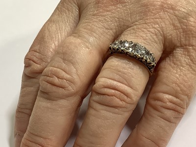 Lot 17 - A diamond five stone half hoop ring.