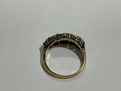 Lot 17 - A diamond five stone half hoop ring.