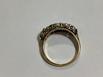 Lot 17 - A diamond five stone half hoop ring.