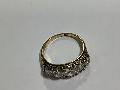 Lot 17 - A diamond five stone half hoop ring.