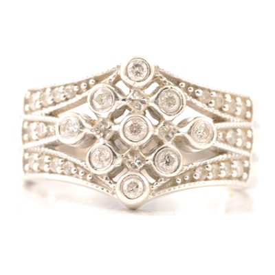 Lot 23 - A diamond multi stone half hoop ring.