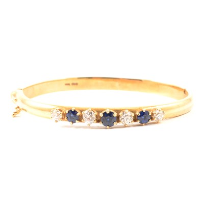 Lot 157A - A sapphire and diamond bangle.